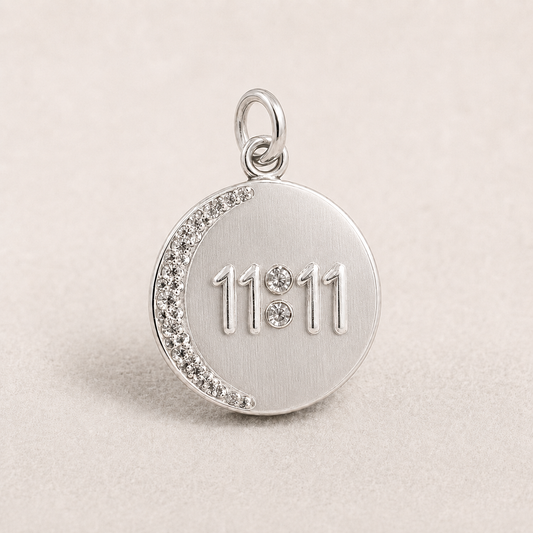 Round 925 silver 11:11 angel number pendant with crystal trim on a light fabric background