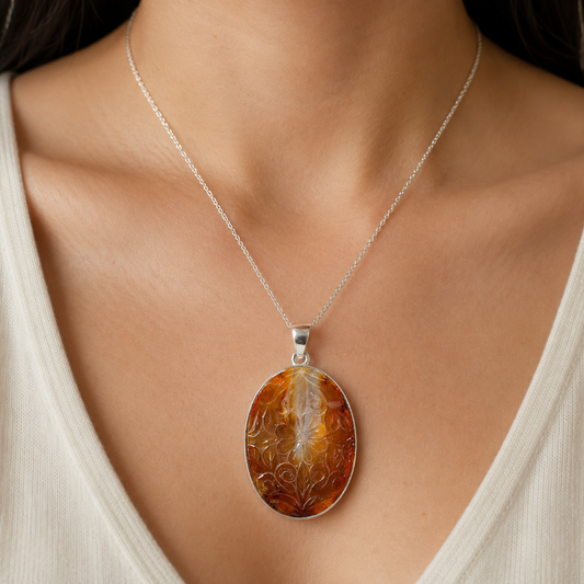 925 silver carved carnelian pendant worn on a fine silver chain against skin