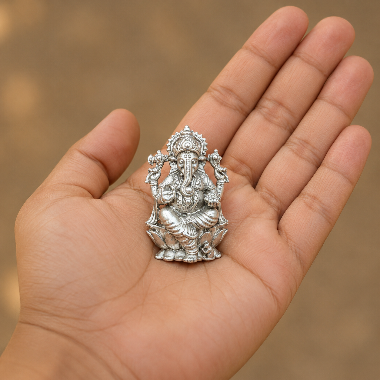 925 silver Lord Ganesha murti held in an open hand, showing seated pose and details