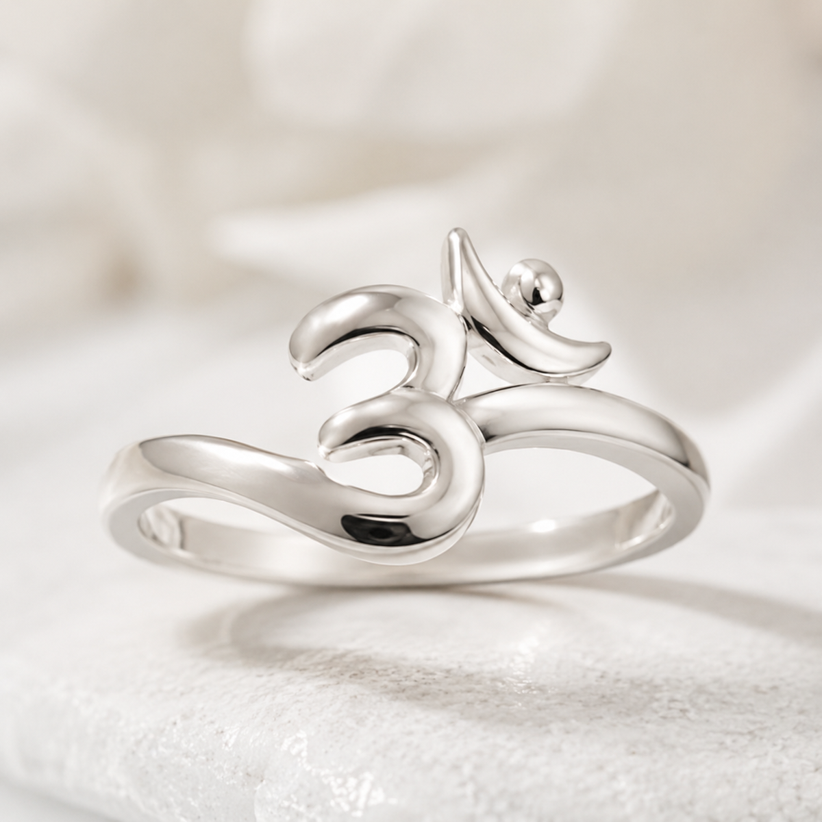 925 silver om symbol ring close-up on white studio background peace design