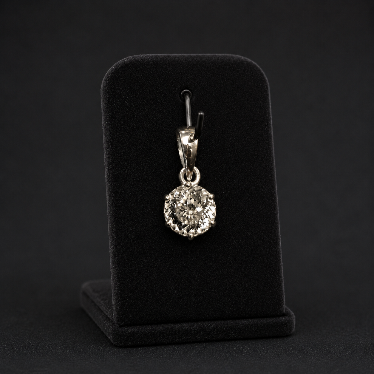 Round cubic zirconia pendant in 925 silver shown on a black jewelry display stand