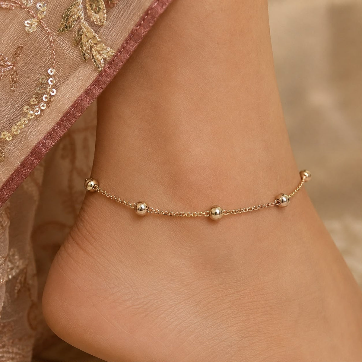 925 sterling silver ball chain anklet with round bead charms on a woman’s ankle