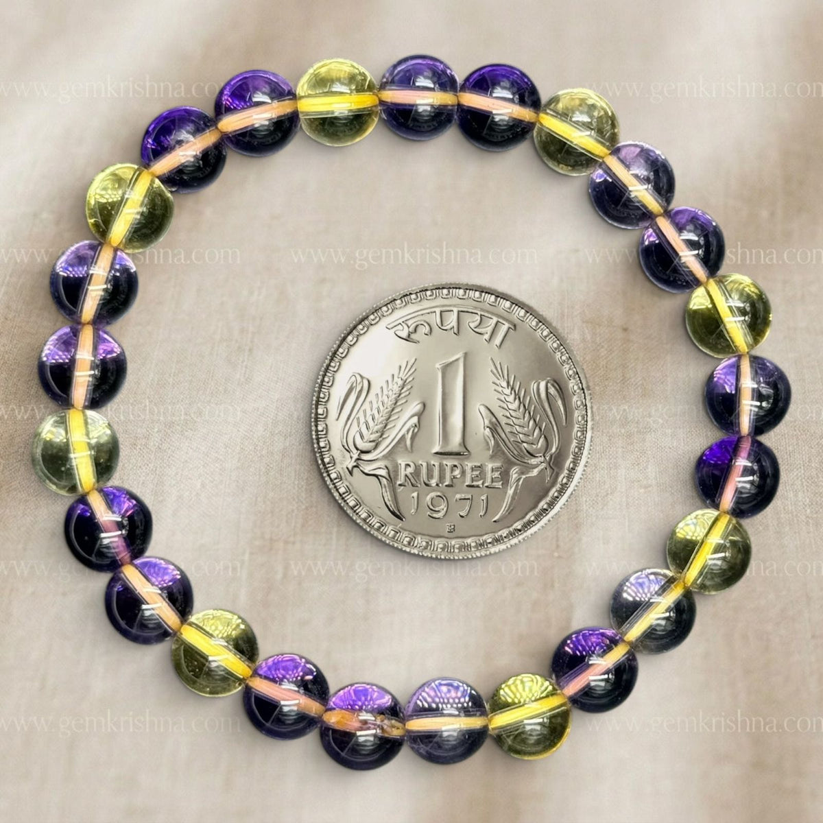 Ametrine bracelet with purple and yellow 8mm beads on a gray background