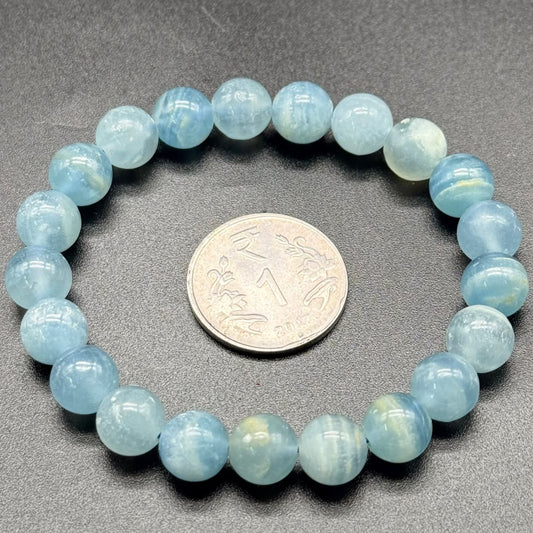Blue Calcite AAA Bracelet round beads arranged in a circle with an Indian one rupee coin inside