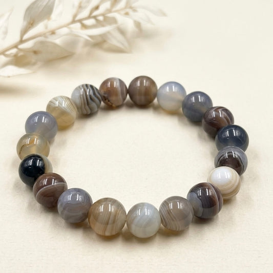 Botswana agate Sulemani Hakik beaded bracelet shown from above with small dried flowers