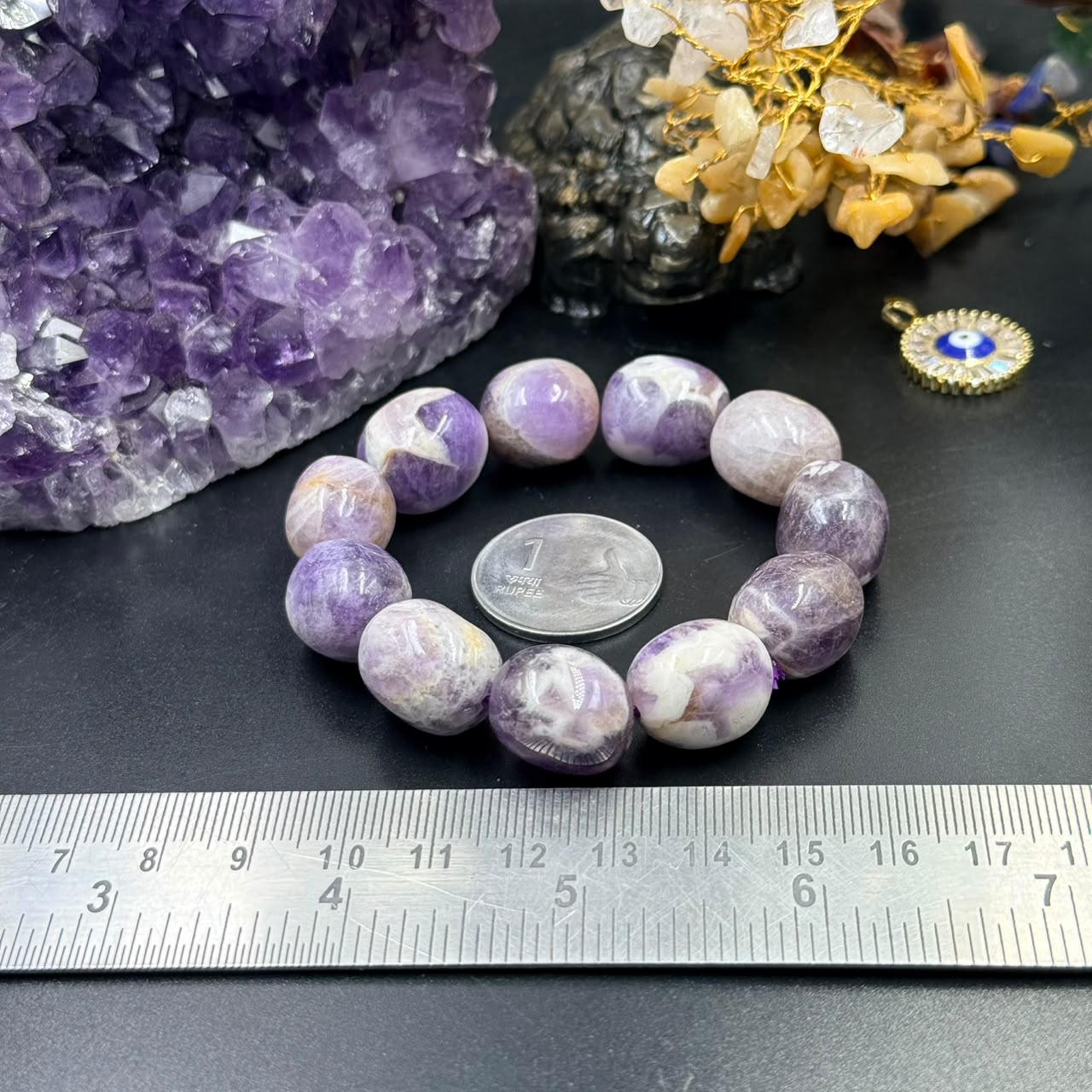 Chevron amethyst tumble bracelet with rounded lavender and white beads on a dark surface
