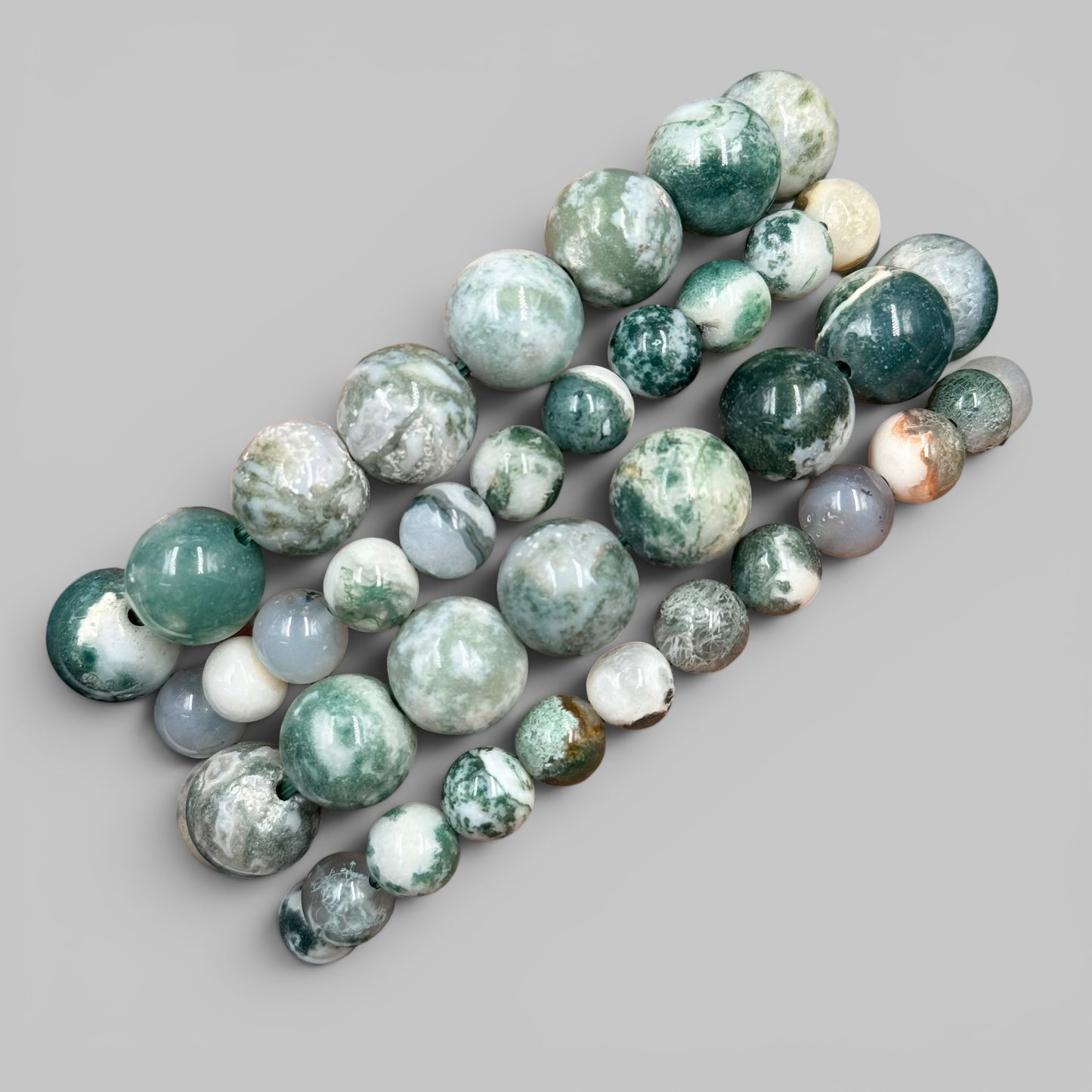 Natural tree agate bead bracelet close-up of green and white round beads