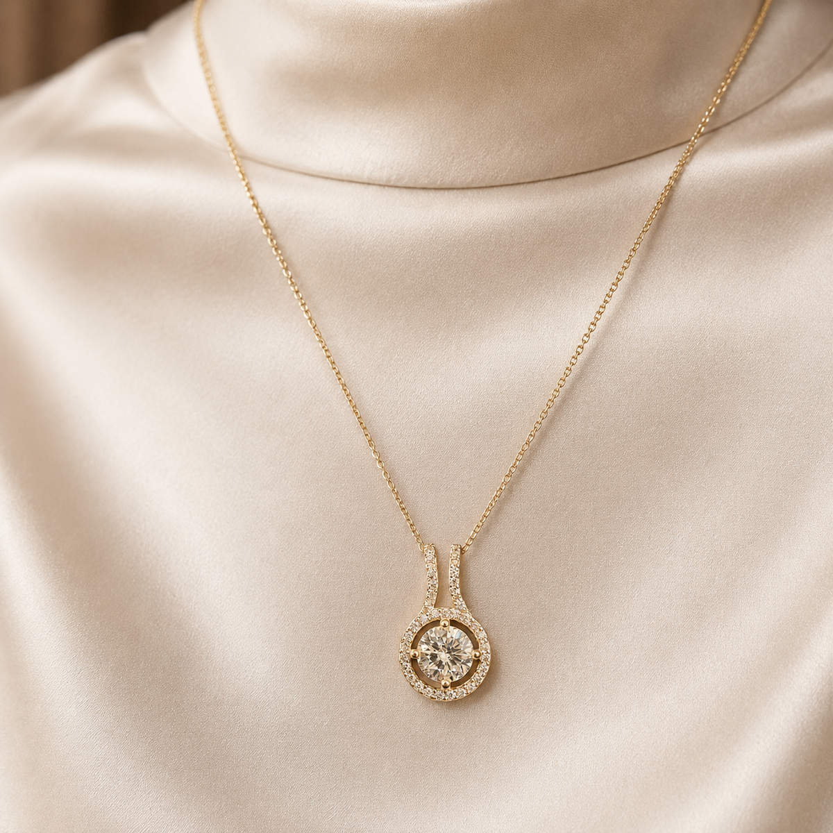 CZ solitaire 925 sterling silver halo pendant worn on a gold-tone chain against satin fabric