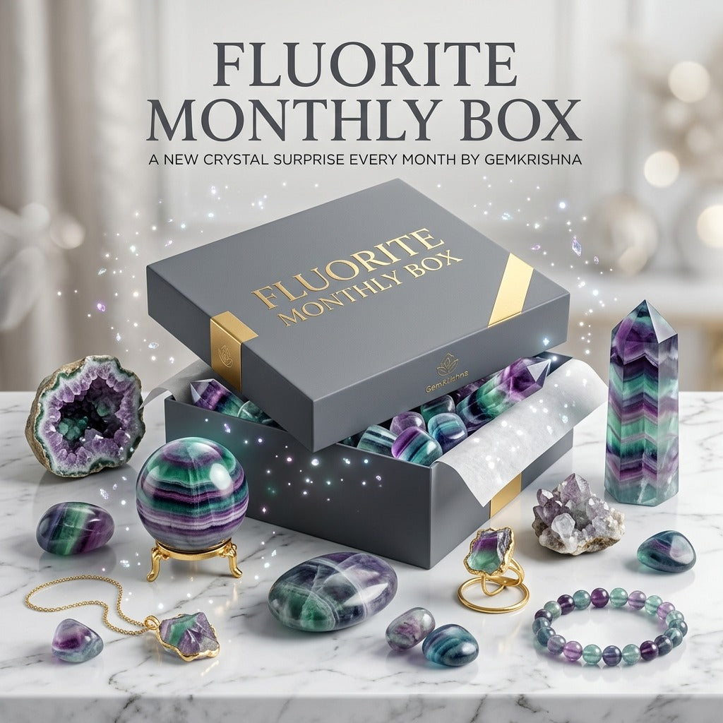 Fluorite Monthly Box gift set with crystals, polished stones, and bracelets on a marble surface