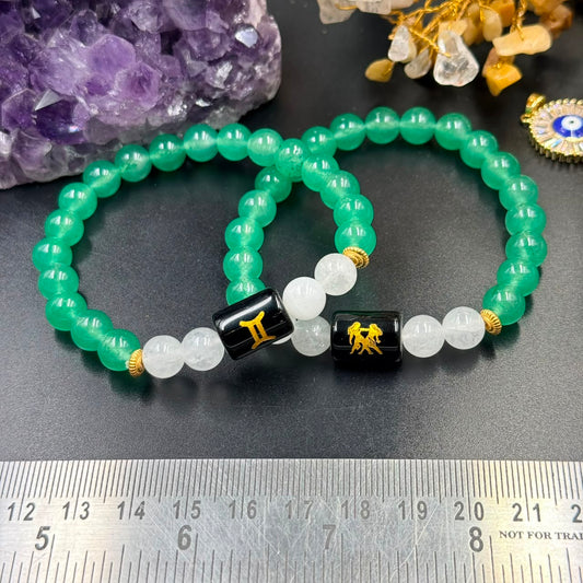 Gemini zodiac bracelet showing green beads, milky quartz accents, and black centerpiece bead