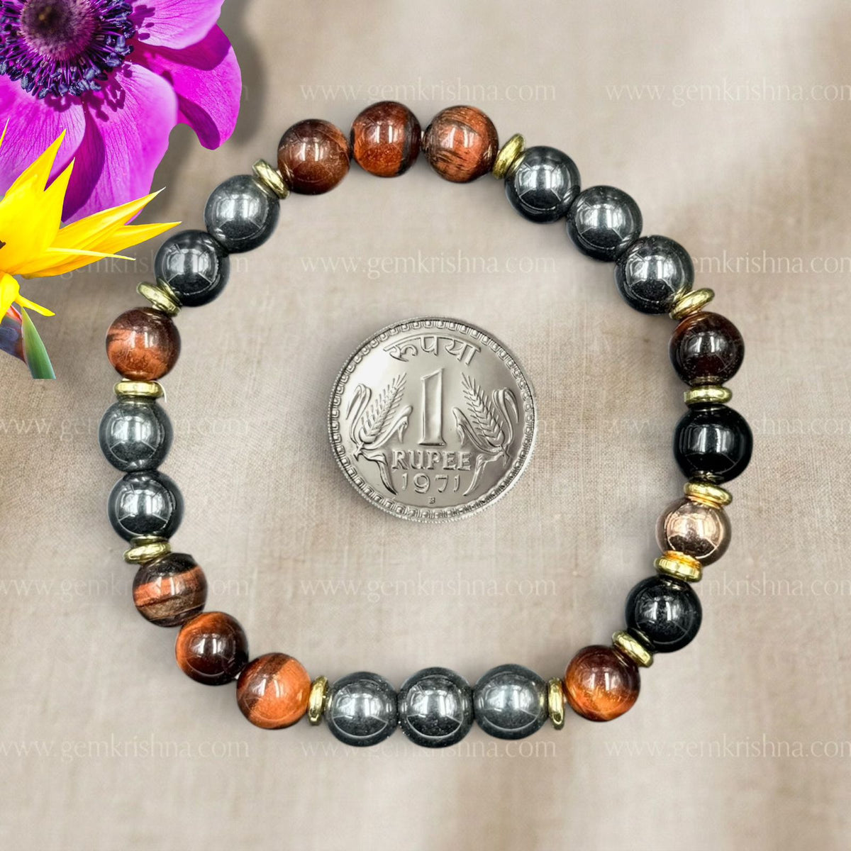 Hematite and red tiger’s eye beaded bracelet with gold spacers, flat lay view