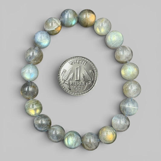 Labradorite bracelet with round polished beads displayed in a full circle with coin
