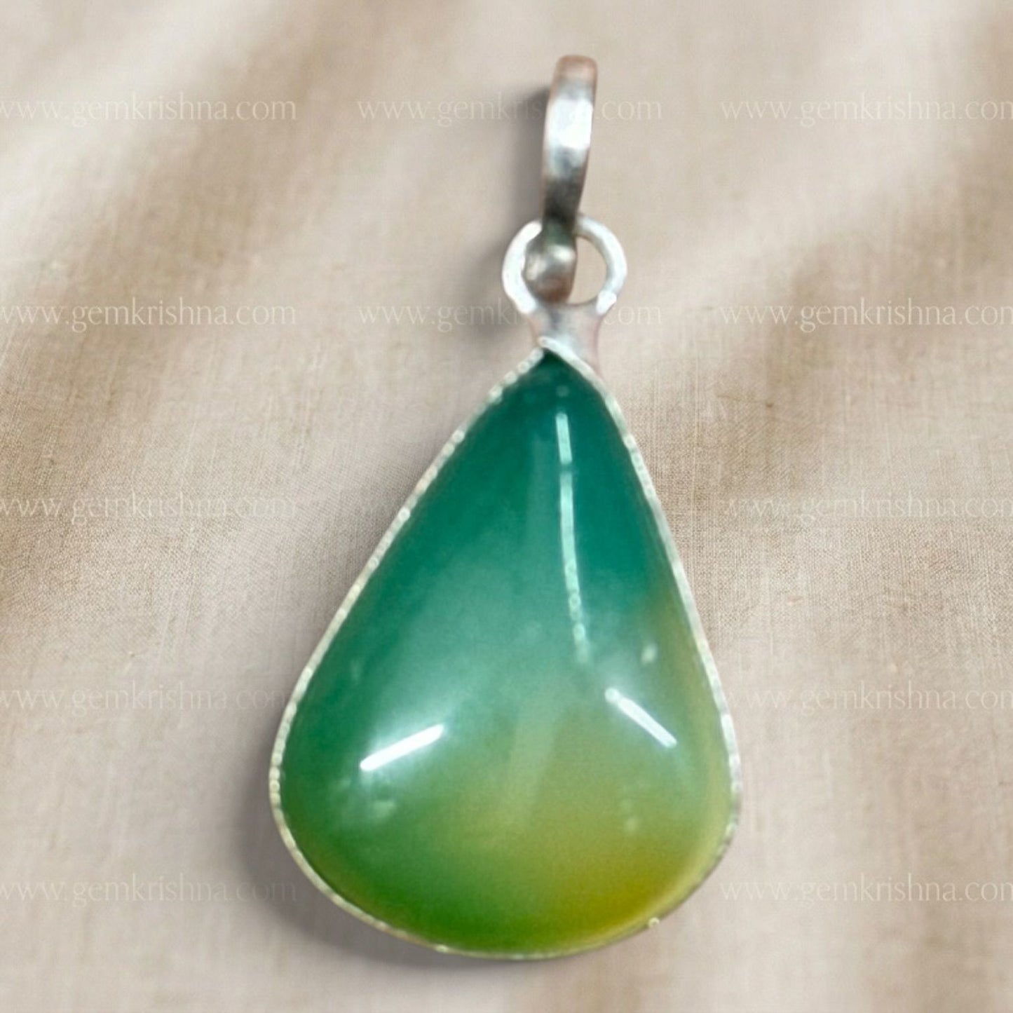 Close-up of multi-color onyx locket pendant teardrop stone in silver-tone setting