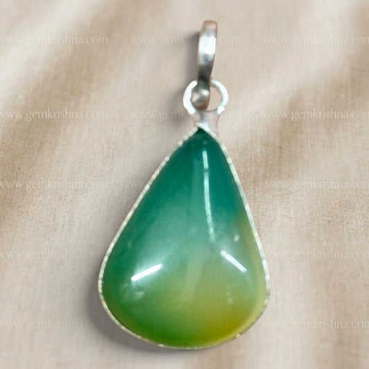 Close-up of multi-color onyx locket pendant teardrop stone in silver-tone setting
