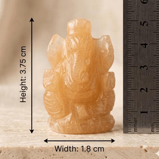 Natural calcite Ganesh Ji carving figurine size shown beside a ruler