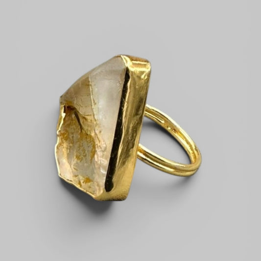 Natural citrine rough metal ring showing golden band and crystal setting, side angle view
