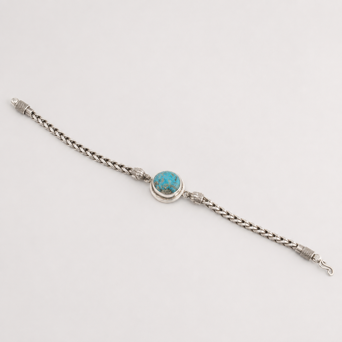 Unisex oval turquoise 925 sterling silver bracelet laid flat with blue oval stone and lobster clasp