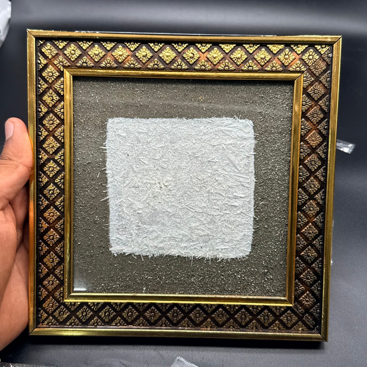 Raw pyrite and selenite frame with glittery white crystal display on textured backing