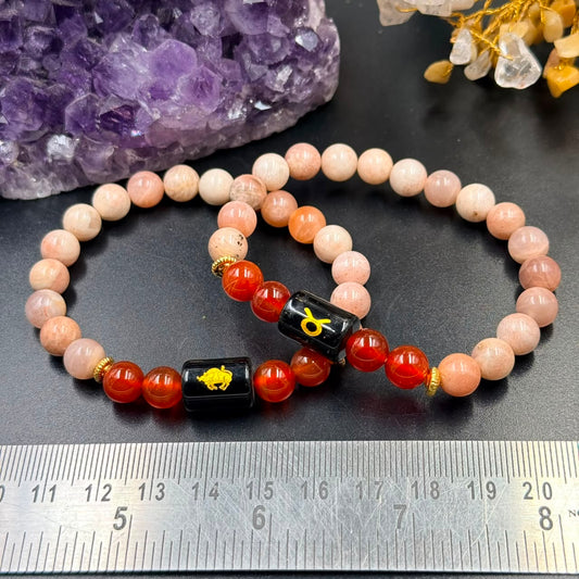 Taurus zodiac bracelet with sunstone and carnelian beads, black square center with gold bull symbol