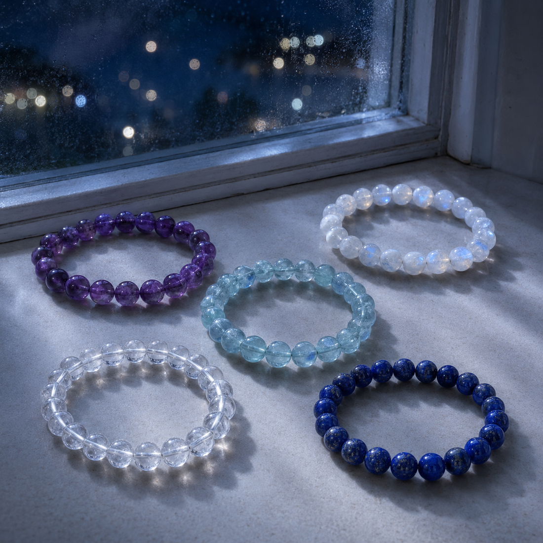 Gemstone bracelet resting in soft moonlight beside a window