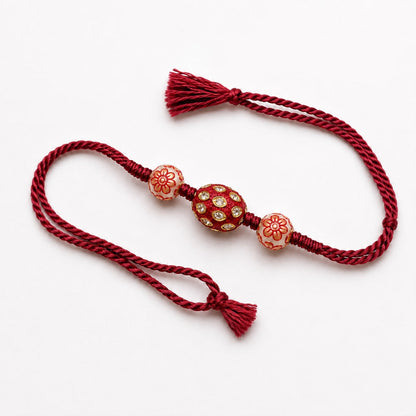 Red Kundan Bead Rakhi with Floral Centrepiece