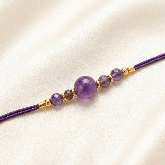 Amethyst Crystal Rakhi with round purple beads and gold spacer beads on purple thread