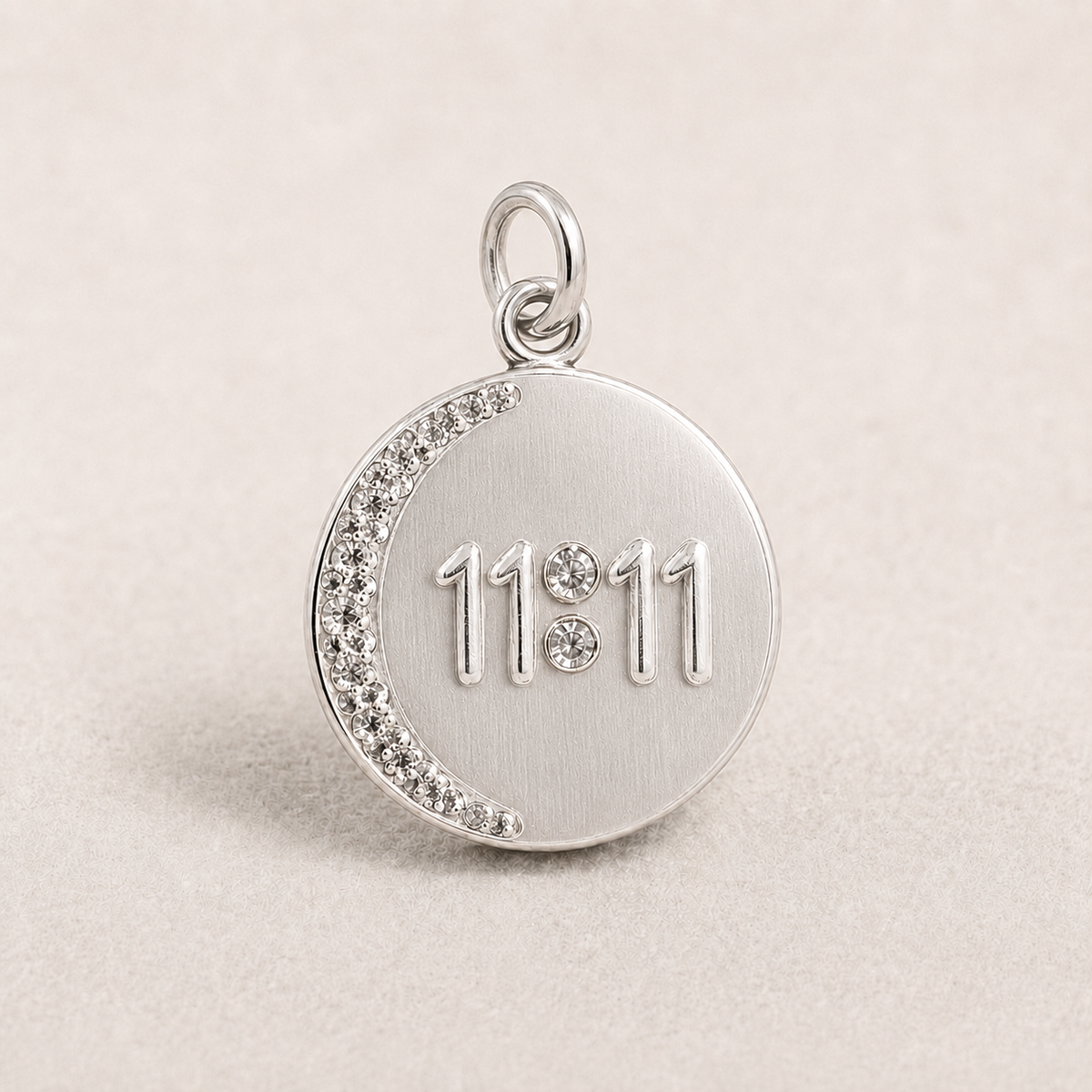 Round 925 silver 11:11 angel number pendant with crystal trim on a light fabric background