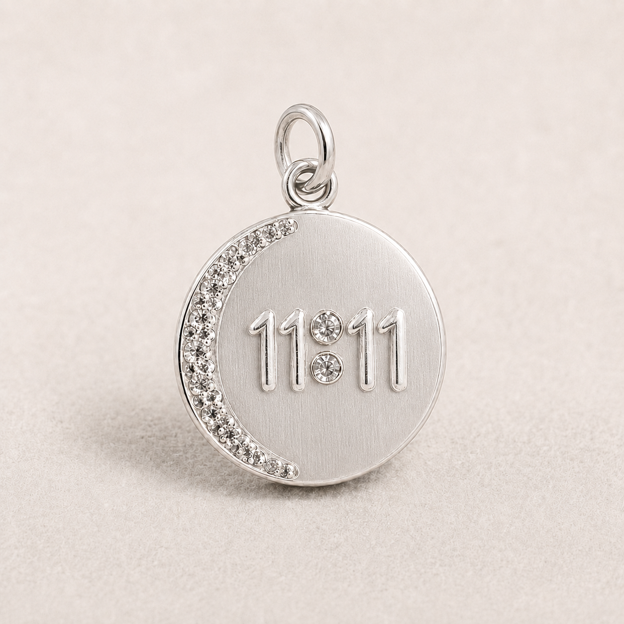 Round 925 silver 11:11 angel number pendant with crystal trim on a light fabric background