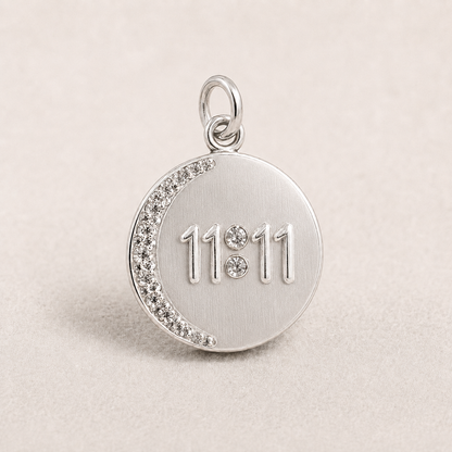 Round 925 silver 11:11 angel number pendant with crystal trim on a light fabric background