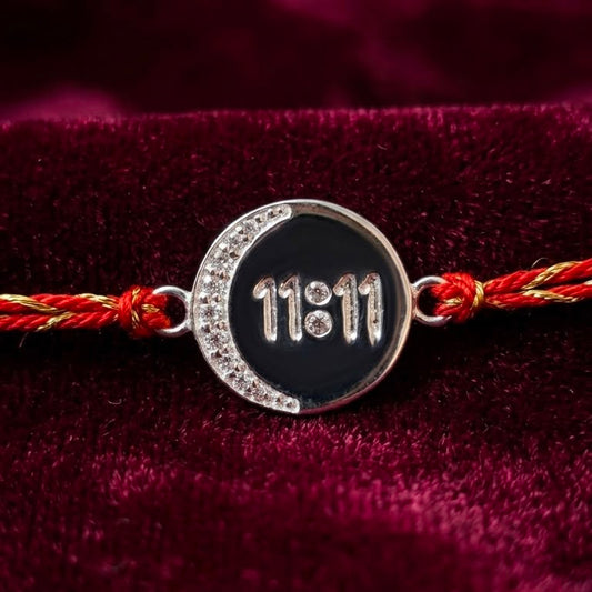 Silver 11:11 angel number rakhi bracelet on red braided thread with black enamel
