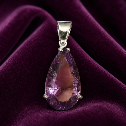 925 silver pear-cut amethyst pendant in a bezel setting on purple velvet