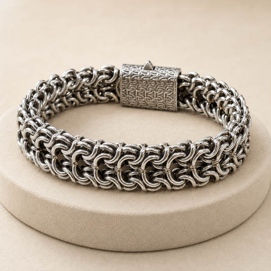 925 silver men’s Byzantine chain bracelet with textured clasp on beige jewelry display