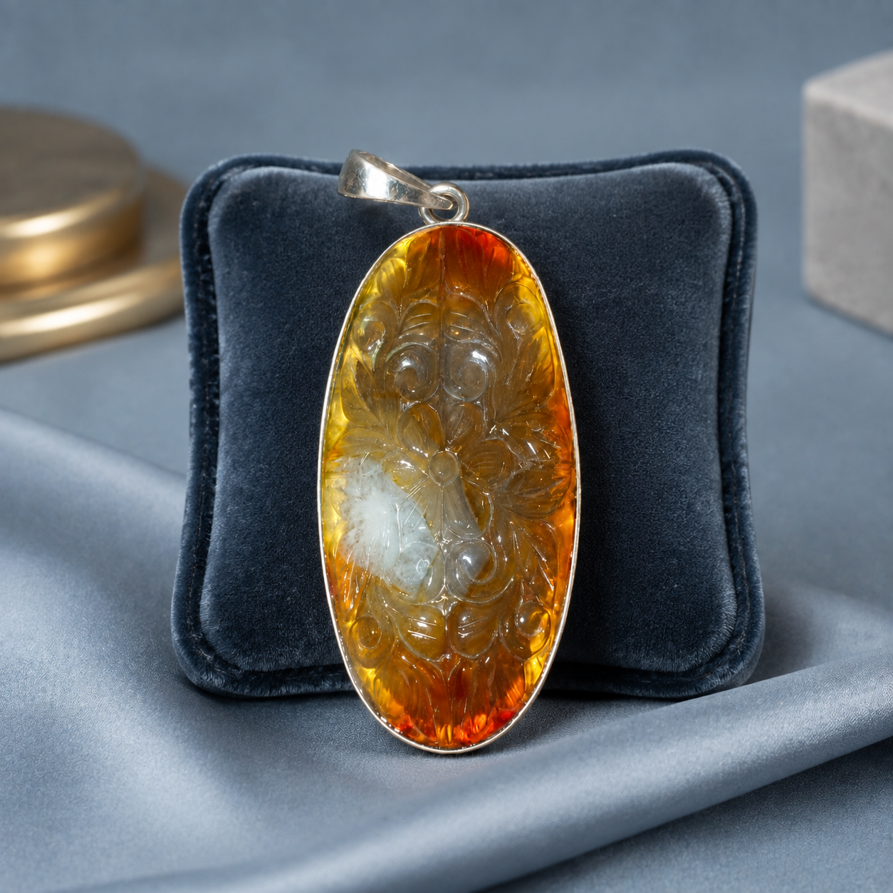 925 silver pendant with oval carnelian cabochon in ornate setting on dark velvet