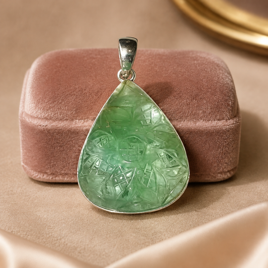 925 silver carved green fluorite teardrop pendant on pink velvet display