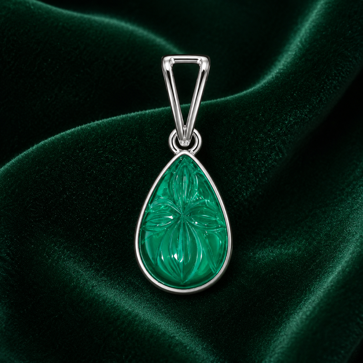 925 silver teardrop green onyx pendant with carved leaf pattern on dark green velvet