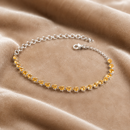 925 silver citrine sunela bracelet with pear-cut golden gemstones and chain clasp on beige suede