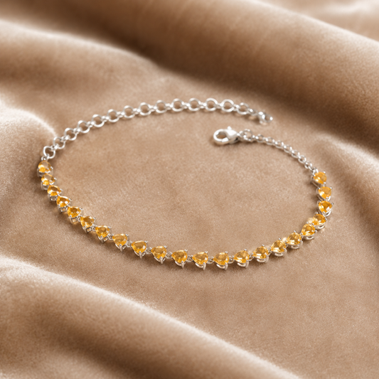 925 silver citrine sunela bracelet with pear-cut golden gemstones and chain clasp on beige suede