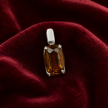 925 silver cushion-cut glass garnet pendant on red velvet background