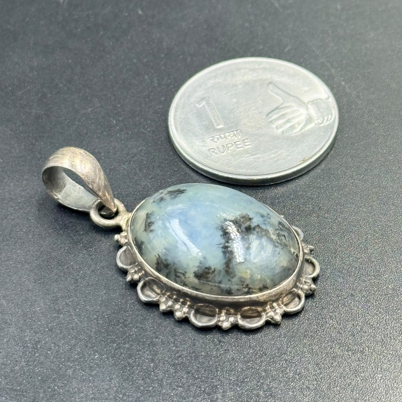 925 silver locket pendant with dendritic opal, shown beside a quarter for scale