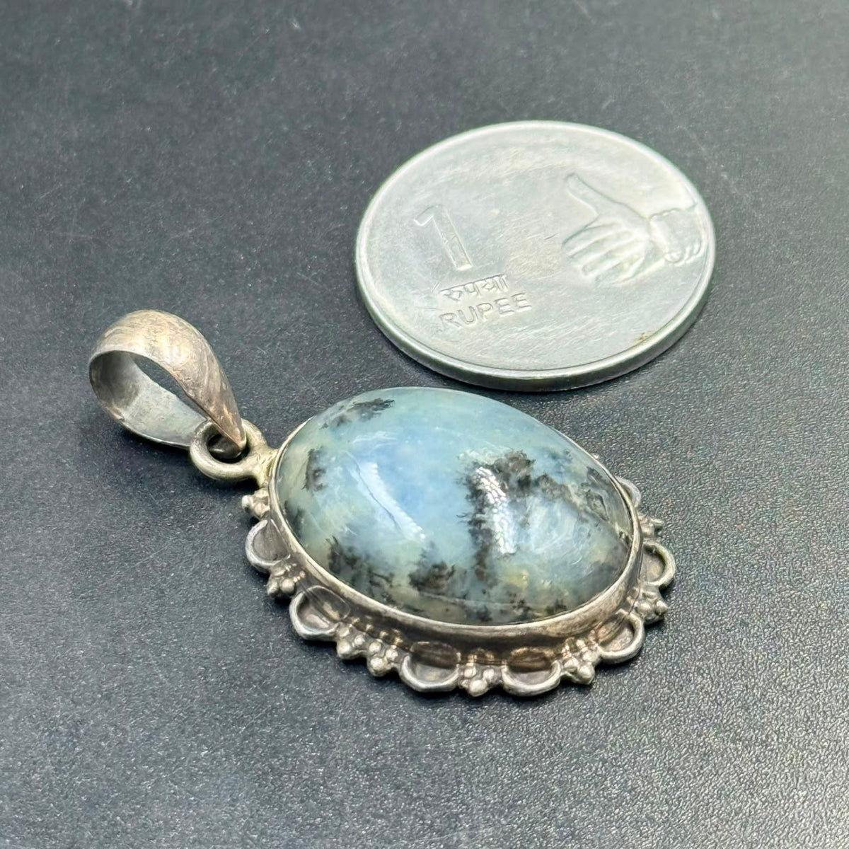 925 silver locket pendant with dendritic opal, shown beside a quarter for scale