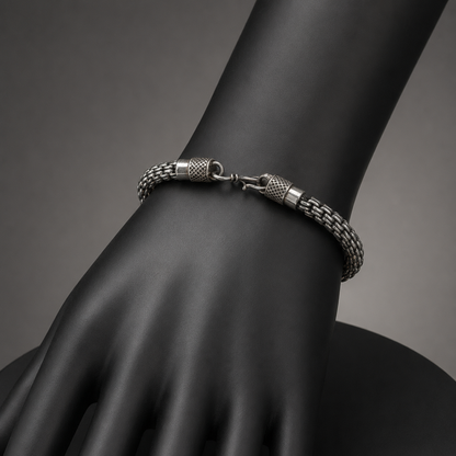 925 silver men’s double lion-head bracelet on a black display bust, showing clasp and chain links