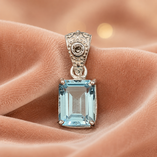 925 silver pendant with emerald-cut blue topaz and lab-grown diamond halo, close-up on velvet