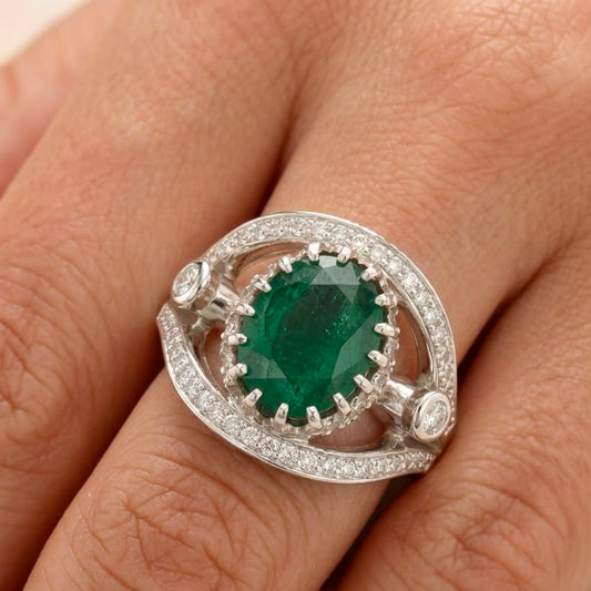 Emerald panna ring in 925 silver with clear cubic zirconia halo on finger close-up