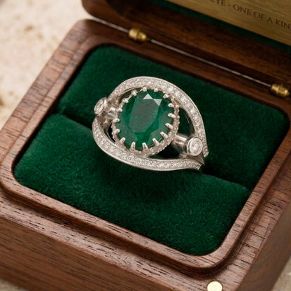 925 silver emerald panna ring with clear cubic zirconia halo displayed on green velvet