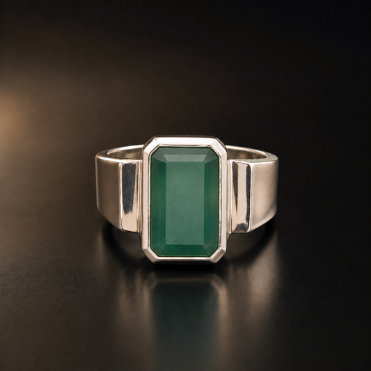 925 silver emerald panna ring with rectangular green gemstone front view on dark background