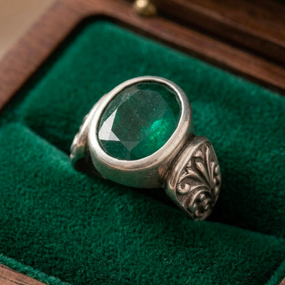 925 silver emerald panna ring resting on green velvet cushion with oval gemstone