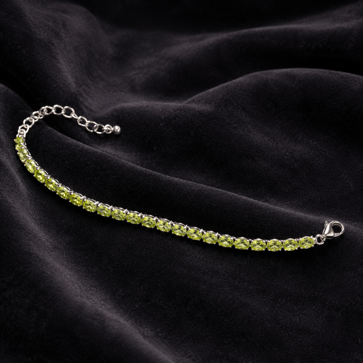 925 silver green peridot tennis bracelet with heart clasp on dark satin background