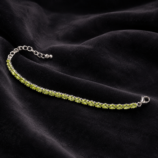 925 silver green peridot tennis bracelet with heart clasp on dark satin background