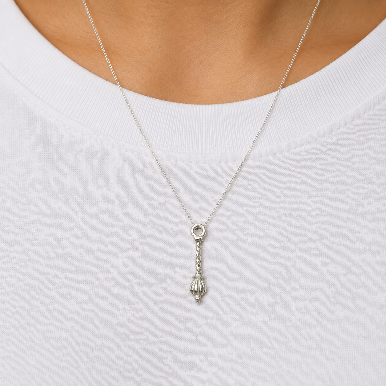 925 silver Hanuman gada locket pendant with spiral handle worn on a chain against white fabric