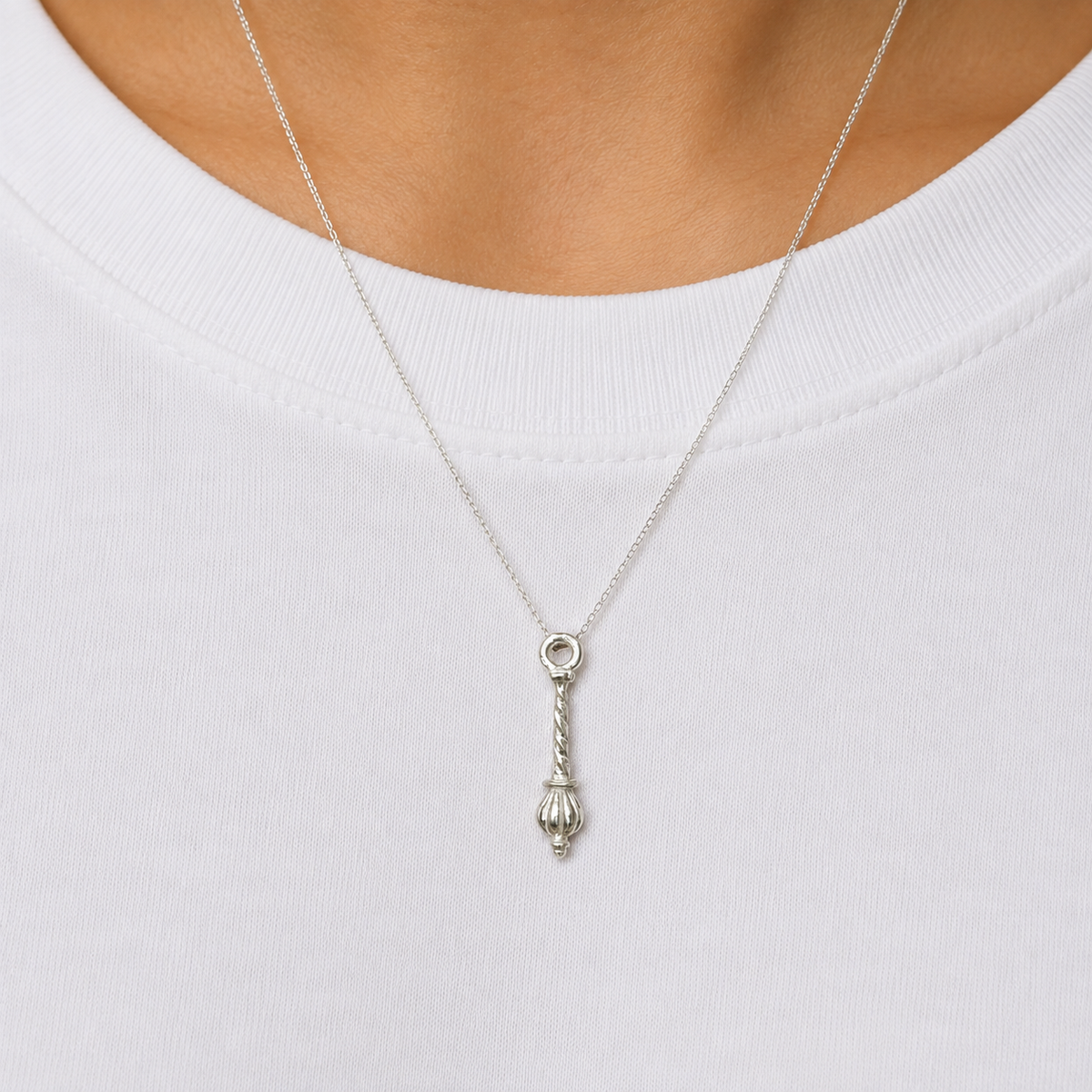 925 silver Hanuman gada locket pendant with spiral handle worn on a chain against white fabric